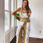 Light olive green washed cotton overalls with pastel floral patchwork throughout including on the adjustable traps with metal clasps and zippered sides.