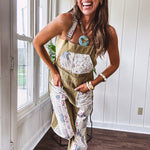 Light olive green washed cotton overalls with pastel floral patchwork throughout including on the adjustable traps with metal clasps and zippered sides.