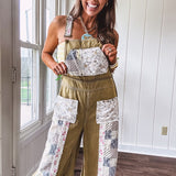 Light olive green washed cotton overalls with pastel floral patchwork throughout including on the adjustable traps with metal clasps and zippered sides.