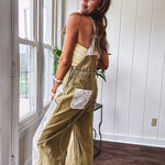 Light olive green washed cotton overalls with pastel floral patchwork throughout including on the adjustable traps with metal clasps and zippered sides.