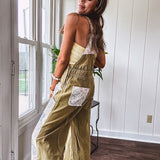 Light olive green washed cotton overalls with pastel floral patchwork throughout including on the adjustable traps with metal clasps and zippered sides.