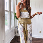 Light olive green washed cotton overalls with pastel floral patchwork throughout including on the adjustable traps with metal clasps and zippered sides.