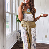 Light olive green washed cotton overalls with pastel floral patchwork throughout including on the adjustable traps with metal clasps and zippered sides.