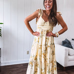 Flowy and soft butter yellow and floral midi dress with eyelet detail on the tie straps, detailed bodice with smocking at the back and a tiered skirt, fully lined.