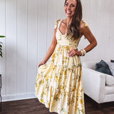 Flowy and soft butter yellow and floral midi dress with eyelet detail on the tie straps, detailed bodice with smocking at the back and a tiered skirt, fully lined.