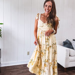 Flowy and soft butter yellow and floral midi dress with eyelet detail on the tie straps, detailed bodice with smocking at the back and a tiered skirt, fully lined.