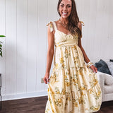 Flowy and soft butter yellow and floral midi dress with eyelet detail on the tie straps, detailed bodice with smocking at the back and a tiered skirt, fully lined.