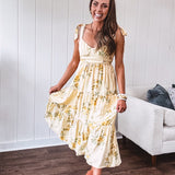 Flowy and soft butter yellow and floral midi dress with eyelet detail on the tie straps, detailed bodice with smocking at the back and a tiered skirt, fully lined.