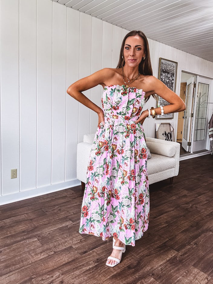 Pink strapless midi dress with floral and berry motif in red, blue and white with pleated front bodice and back smocked bodice, fully lined pleated skirt, with pockets.
