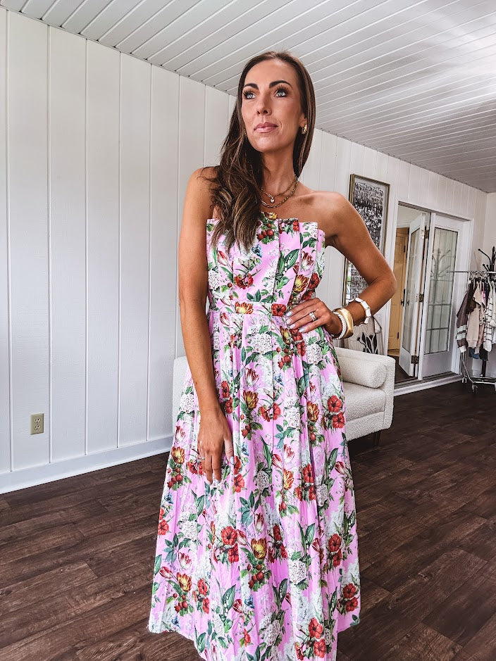 Pink strapless midi dress with floral and berry motif in red, blue and white with pleated front bodice and back smocked bodice, fully lined pleated skirt, with pockets.