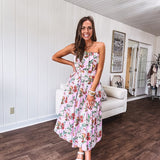 Pink strapless midi dress with floral and berry motif in red, blue and white with pleated front bodice and back smocked bodice, fully lined pleated skirt, with pockets.