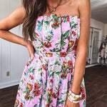 Pink strapless midi dress with floral and berry motif in red, blue and white with pleated front bodice and back smocked bodice, fully lined pleated skirt, with pockets.