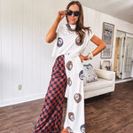 Soft cap sleeved mock neck cream top with a shorter waist and black and leo 8 ball motif throughout.