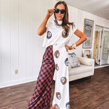 Soft cap sleeved mock neck cream top with a shorter waist and black and leo 8 ball motif throughout.