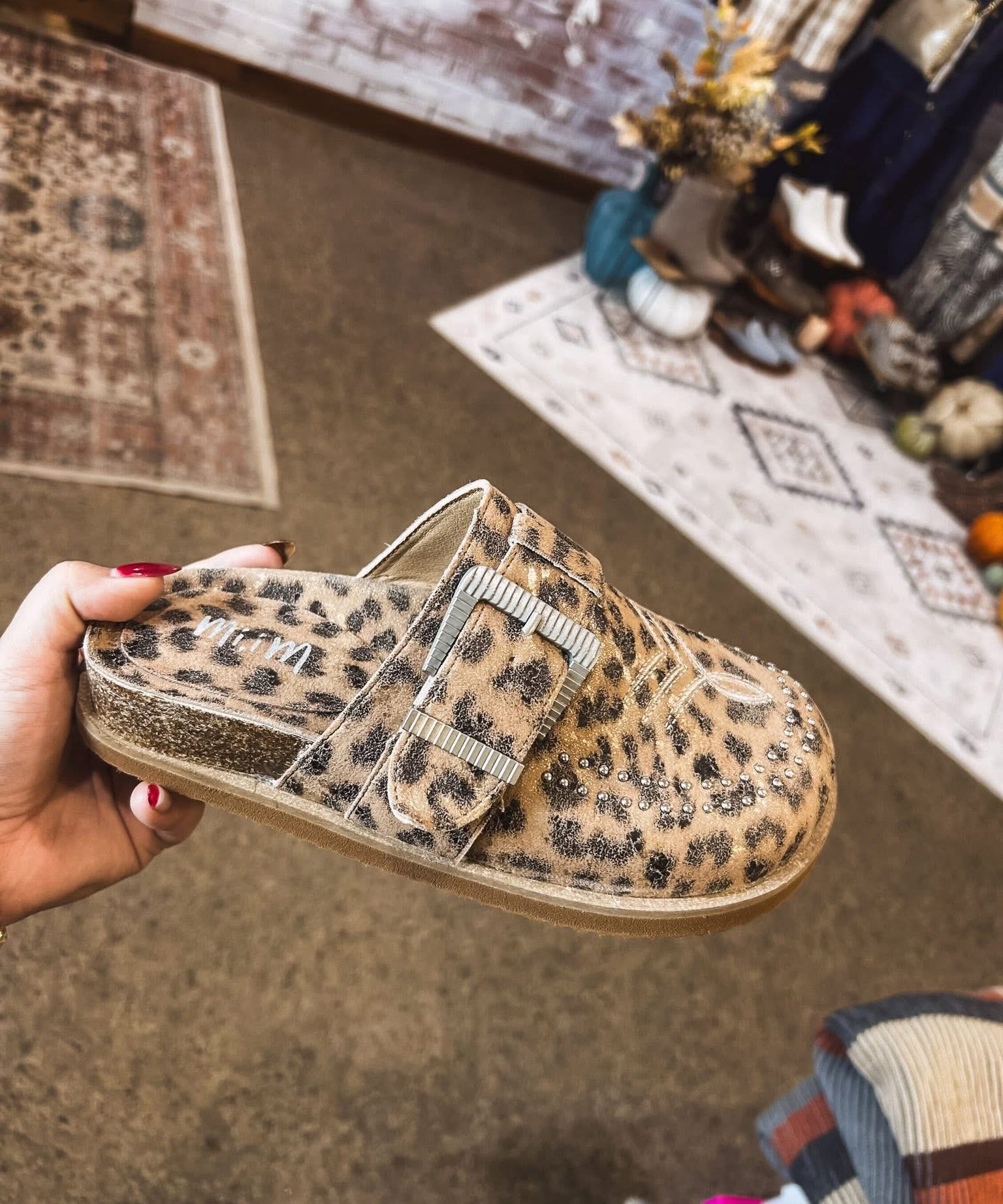Leo print flat clog shoe with oversized buckle and western print and design.