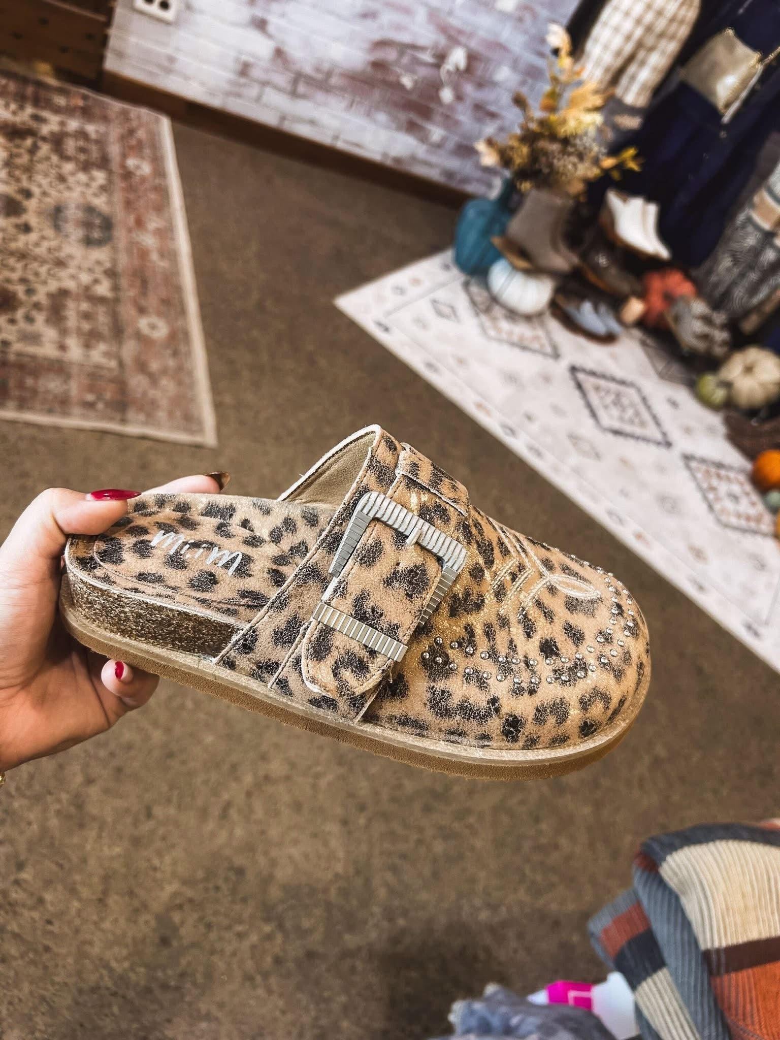 Leo print flat clog shoe with oversized buckle and western print and design.