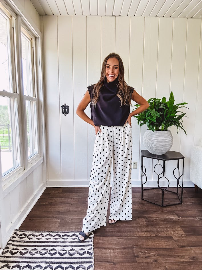 Wide leg, pleated front ivory and black polka dot pants with hidden elastic waist, side zip and pockets.