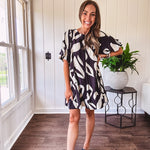 Short black and ivory abstract print dress, fully lined with hook and eye neck closure and puffed sleeves.