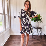 Short black and ivory abstract print dress, fully lined with hook and eye neck closure and puffed sleeves.