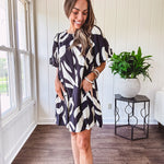 Short black and ivory abstract print dress, fully lined with hook and eye neck closure and puffed sleeves.