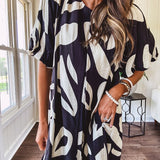 Short black and ivory abstract print dress, fully lined with hook and eye neck closure and puffed sleeves.