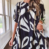 Short black and ivory abstract print dress, fully lined with hook and eye neck closure and puffed sleeves.