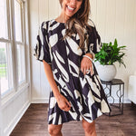 Short black and ivory abstract print dress, fully lined with hook and eye neck closure and puffed sleeves.