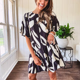 Short black and ivory abstract print dress, fully lined with hook and eye neck closure and puffed sleeves.
