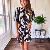 Short black and ivory abstract print dress, fully lined with hook and eye neck closure and puffed sleeves.