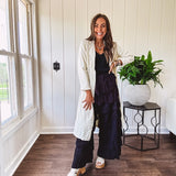 Midi length ivory and small black polka dot long sleeved duster with silver buttons and pockets.