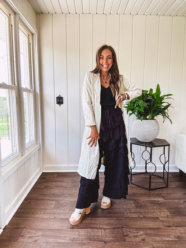 Midi length ivory and small black polka dot long sleeved duster with silver buttons and pockets.