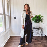 Midi length ivory and small black polka dot long sleeved duster with silver buttons and pockets.