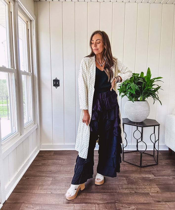 Midi length ivory and small black polka dot long sleeved duster with silver buttons and pockets.
