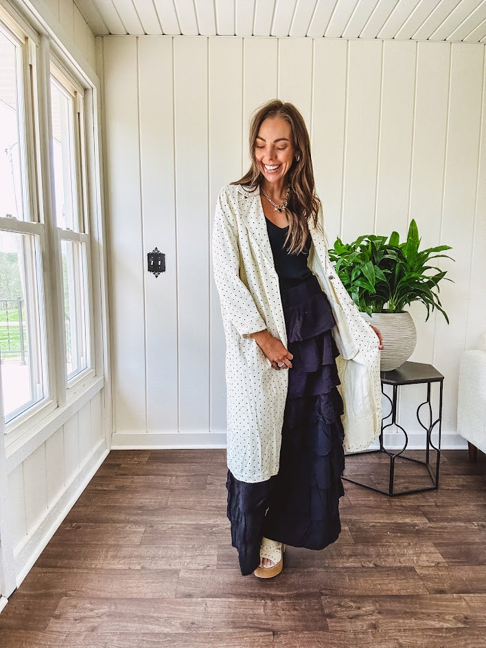 Midi length ivory and small black polka dot long sleeved duster with silver buttons and pockets.
