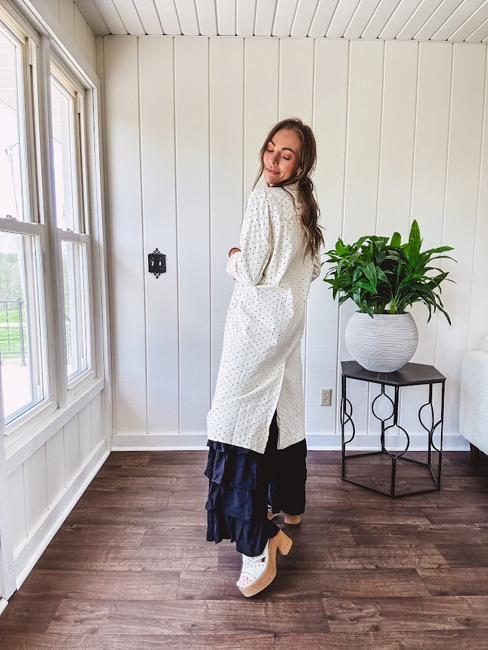 Midi length ivory and small black polka dot long sleeved duster with silver buttons and pockets.