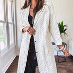 Midi length ivory and small black polka dot long sleeved duster with silver buttons and pockets.