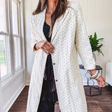 Midi length ivory and small black polka dot long sleeved duster with silver buttons and pockets.
