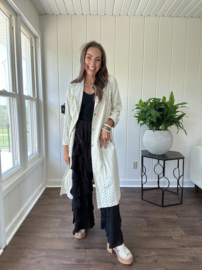 Midi length ivory and small black polka dot long sleeved duster with silver buttons and pockets.