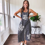 Thin, lightweight black and ivory striped overalls featuring black and ivory lace crochet patches throughout and faux wooden buttons at the adjustable straps and sides.