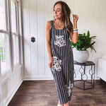 Thin, lightweight black and ivory striped overalls featuring black and ivory lace crochet patches throughout and faux wooden buttons at the adjustable straps and sides.