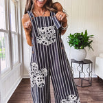 Thin, lightweight black and ivory striped overalls featuring black and ivory lace crochet patches throughout and faux wooden buttons at the adjustable straps and sides.