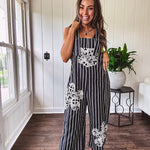 Thin, lightweight black and ivory striped overalls featuring black and ivory lace crochet patches throughout and faux wooden buttons at the adjustable straps and sides.