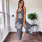 Thin, lightweight black and ivory striped overalls featuring black and ivory lace crochet patches throughout and faux wooden buttons at the adjustable straps and sides.