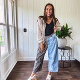 Denim barrel pants with one leg leo print and the other medium wash denim with elastic back waist and button and zipper closure.