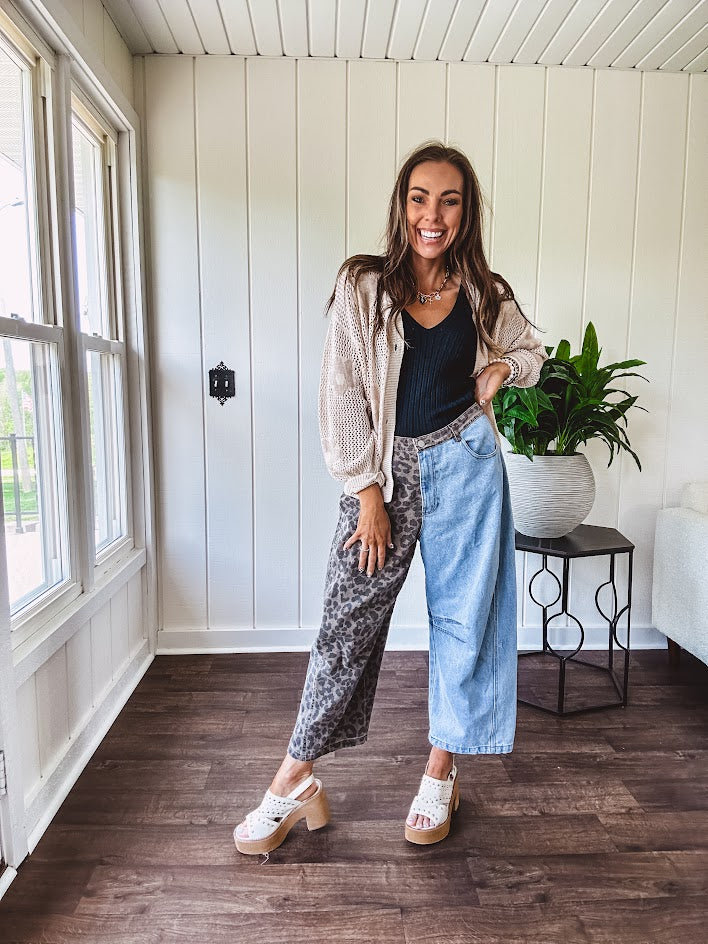 Denim barrel pants with one leg leo print and the other medium wash denim with elastic back waist and button and zipper closure.