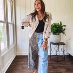 Denim barrel pants with one leg leo print and the other medium wash denim with elastic back waist and button and zipper closure.