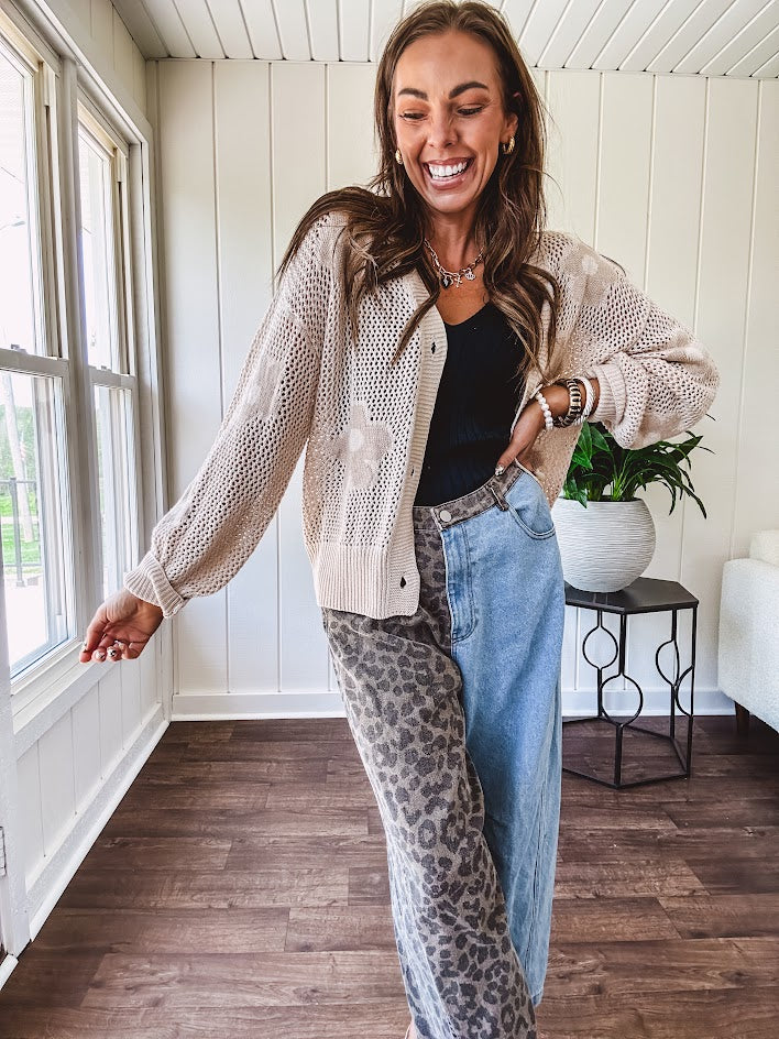 Oatmeal crochet short cardigan with long sleeves and floral motif with three faux wooden button closure.