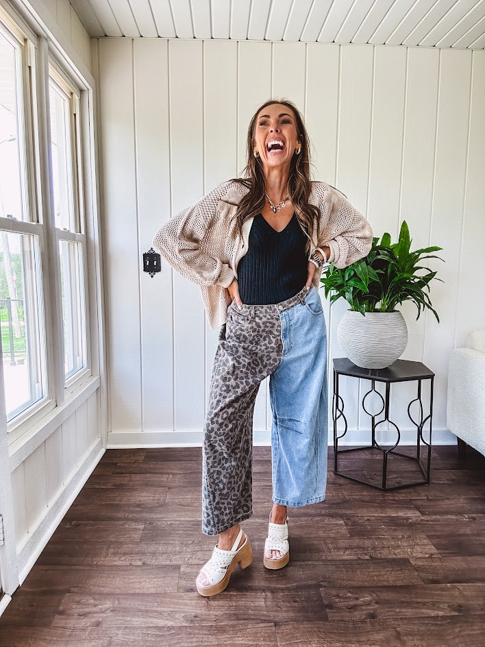 Denim barrel pants with one leg leo print and the other medium wash denim with elastic back waist and button and zipper closure.