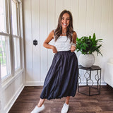 Midi length black athletic style bubble hem skirt with elastic waist and pockets.