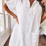 Lined cream denim-like short shift dress with V neck and collar, short sleeves,, contrasting tan stitching, front pocket and eyelet details throughout